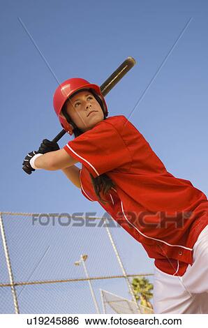 Stock Photograph - Softball player at bat, portrait, low angle view. Fotosearch