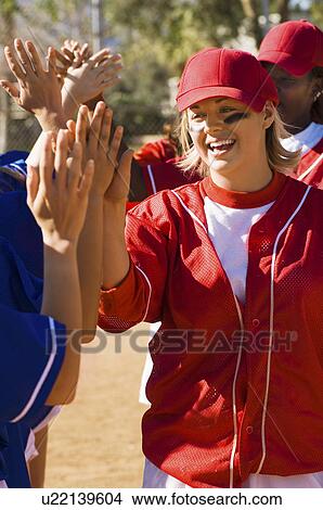 Picture - Softball teams congratulating each other. Fotosearch
