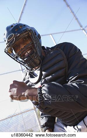 Stock Image - Softball umpire, portrait, low angle view. Fotosearch