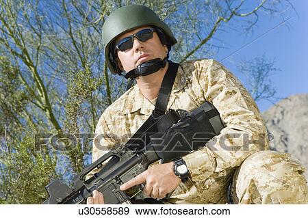 Soldier with rifle, outdoors, (close-up) View Large Photo Image Stock Photo - Soldier with rifle, outdoors, (close-up). Fotosearch