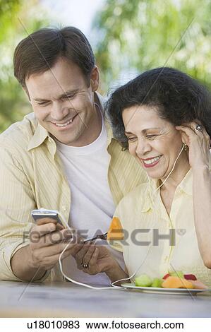 Son Showing Mother How to Use MP3 Player View Large Photo Image Stock Image - Son Showing Mother How to Use MP3 Player. Fotosearch