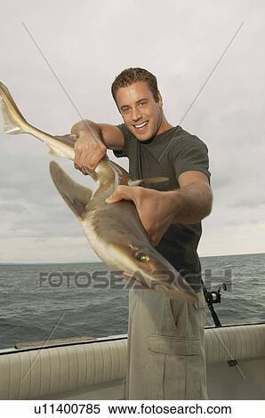 Sport fisherman displaying shark, (portrait) View Large Photo Image Stock Photography - Sport fisherman displaying shark, (portrait). Fotosearch