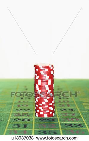 Stock Photo - Stack of gambling chips on roulette table. Fotosearch