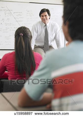 Students and teacher sitting in classroom View Large Photo Image Stock Photo - Students and teacher sitting in classroom. Fotosearch