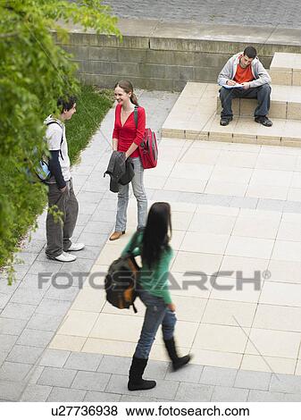 Students sitting and standing on school grounds outdoors, elevated view View Large Photo Image Stock Photo - Students sitting and standing on school grounds outdoors, elevated view. Fotosearch