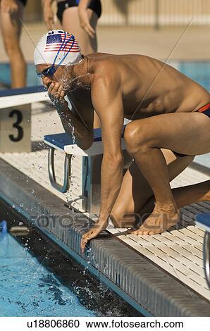 Stock Image - Swimmer Warming Up at Starting Blocks. Fotosearch