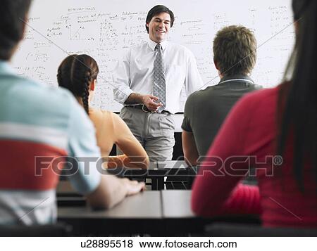 Teacher talking to students in classroom View Large Photo Image Stock Photo - Teacher talking to students in classroom. Fotosearch