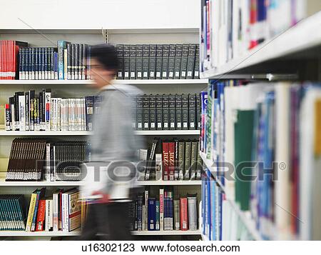 Teenage boy walking through library, motion blur View Large Photo Image Stock Image - Teenage boy walking through library, motion blur. Fotosearch