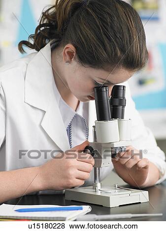 Teenage girl looking through microscope in classroom View Large Photo Image Stock Photo - Teenage girl looking through microscope in classroom. Fotosearch
