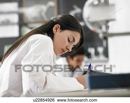Teenager taking notes in science class View Large Photo Image Stock Photograph - Teenager taking notes in science class. Fotosearch