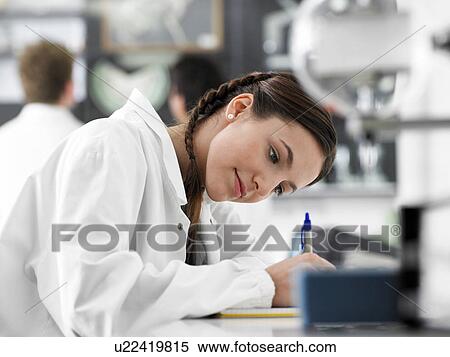 Stock Photography - Teenager writing in science class. Fotosearch