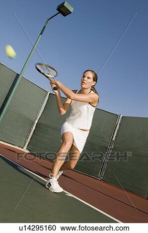 Tennis Player Hitting Backhand on tennis court View Large Photo Image Stock Image - Tennis Player Hitting Backhand on tennis court. Fotosearch