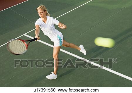 Tennis Player hitting tennis ball with forehand View Large Photo Image Stock Image - Tennis Player hitting tennis ball with forehand. Fotosearch
