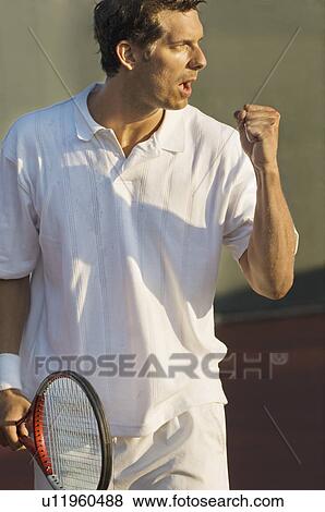 Stock Photo - Tennis Player holding racket, pumping arm. Fotosearch