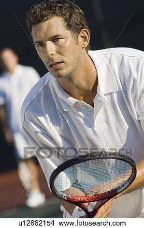 Tennis Player holding racket, Waiting For serve View Large Photo Image Picture - Tennis Player holding racket, Waiting For serve. Fotosearch
