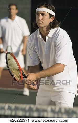 Stock Image - Tennis Player holding racket, Waiting For serve. Fotosearch