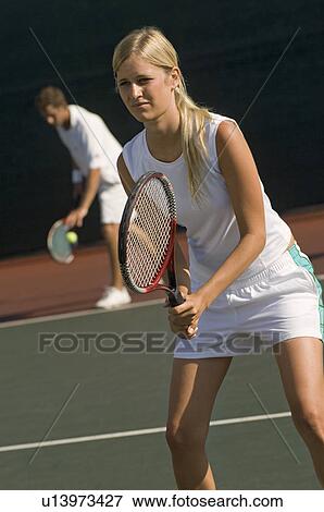 Stock Photo - Tennis Player holding racket, Waiting For doubles partner to Serve. Fotosearch