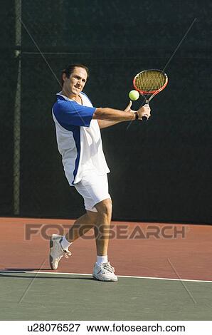 Tennis Player on court, preparing to return tennis ball with backhand View Large Photo Image Stock Photo - Tennis Player on court, preparing to return tennis ball with backhand. Fotosearch