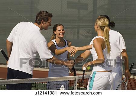 Stock Image - Tennis Players Shaking Hands at Net after tennis match. Fotosearch