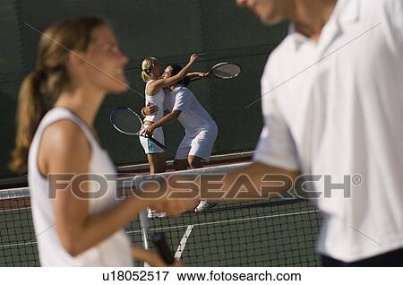 Tennis Players Shaking Hands at Net, side view View Large Photo Image Stock Photo - Tennis Players Shaking Hands at Net, side view. Fotosearch