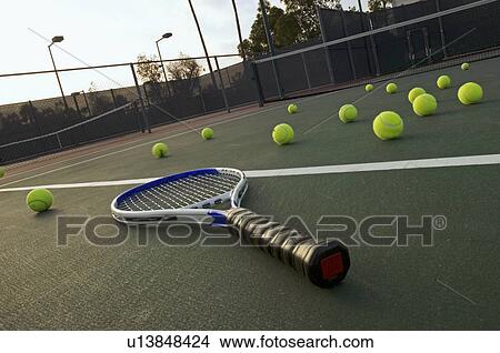 Picture - Tennis Racket and Balls lying on Court. Fotosearch