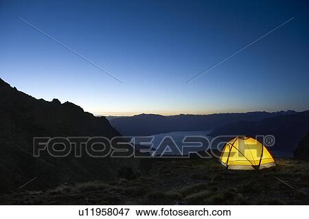Tent by lakeshore at dusk View Large Photo Image Stock Photo - Tent by lakeshore at dusk. Fotosearch