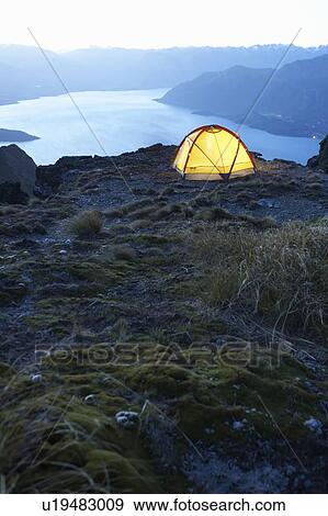Tent by lakeshore at dusk View Large Photo Image Stock Photo - Tent by lakeshore at dusk. Fotosearch