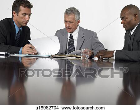 Picture - Three businessmen in conference meeting. Fotosearch