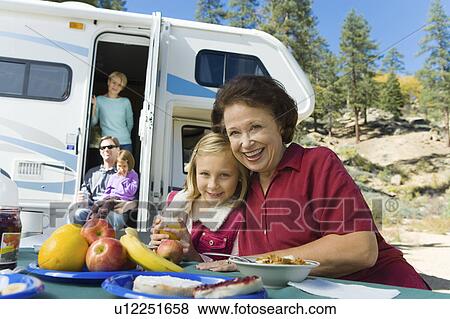 Three-generation family outside RV in campground View Large Photo Image Stock Photo - Three-generation family outside RV in campground. Fotosearch