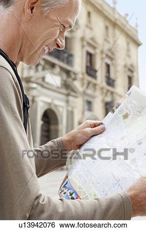 Tourist on Granada street Reading Map, side view View Large Photo Image Stock Photograph - Tourist on Granada street Reading Map, side view. Fotosearch