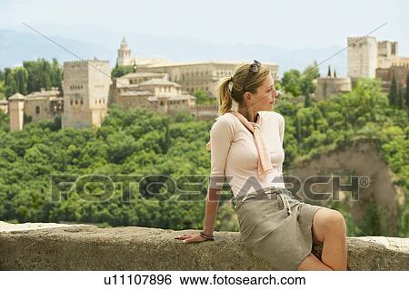 Tourist Relaxing on City Wall, Granada, Spain View Large Photo Image Stock Photograph - Tourist Relaxing on City Wall, Granada, Spain. Fotosearch