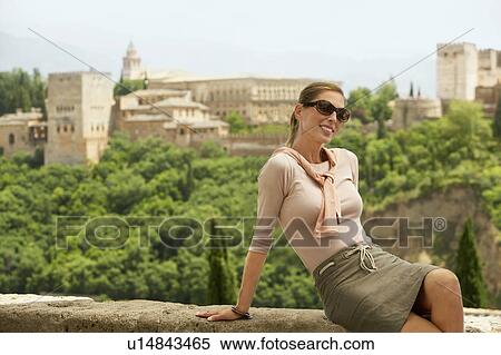 Stock Photography - Tourist Relaxing on City Wall, Granada, Spain, portrait. Fotosearch
