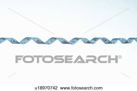 Stock Image - Twisted strip of measuring tape, detail. Fotosearch