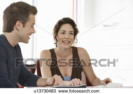 Stock Image - Two business colleagues in office meeting. Fotosearch