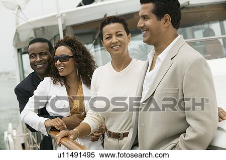 Two couples relaxing on yacht View Large Photo Image Stock Photography - Two couples relaxing on yacht. Fotosearch
