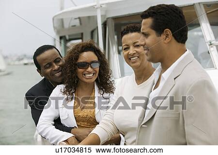 Stock Photography - Two couples relaxing on yacht. Fotosearch