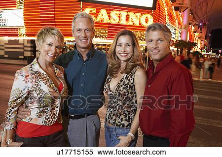 Two couples standing in front of illuminated casino, portrait View Large Photo Image Stock Photography - Two couples standing in front of illuminated casino, portrait. Fotosearch