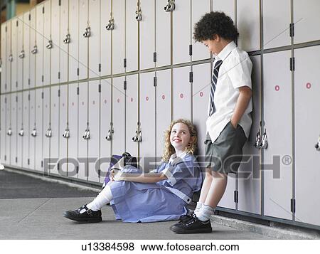 Two elementary school students waiting by school lockers View Large Photo Image Stock Photo - Two elementary school students waiting by school lockers. Fotosearch