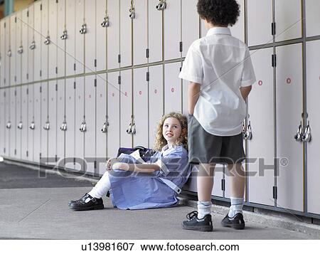 Two elementary school students waiting by school lockers View Large Photo Image Stock Photo - Two elementary school students waiting by school lockers. Fotosearch