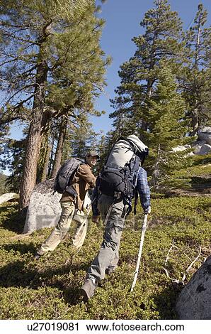 Two hikers climbing hill View Large Photo Image Stock Image - Two hikers climbing hill. Fotosearch