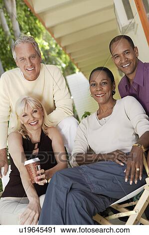 Two mature couples sitting together outdoors View Large Photo Image Stock Image - Two mature couples sitting together outdoors. Fotosearch