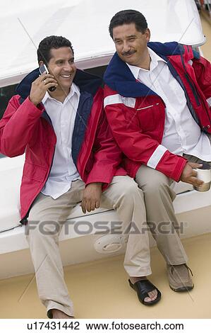 Two men relaxing on yacht, (elevated view) View Large Photo Image Stock Image - Two men relaxing on yacht, (elevated view). Fotosearch