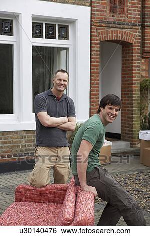 Two men with sofa outside house View Large Photo Image Stock Photograph - Two men with sofa outside house. Fotosearch