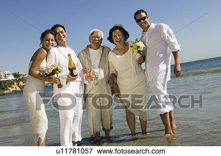 Two newly wed couples and a best man at ocean, (portrait) View Large Photo Image Stock Photo - Two newly wed couples and a best man at ocean, (portrait). Fotosearch