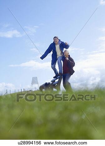 Two senior men goofing around in park View Large Photo Image Stock Photograph - Two senior men goofing around in park. Fotosearch
