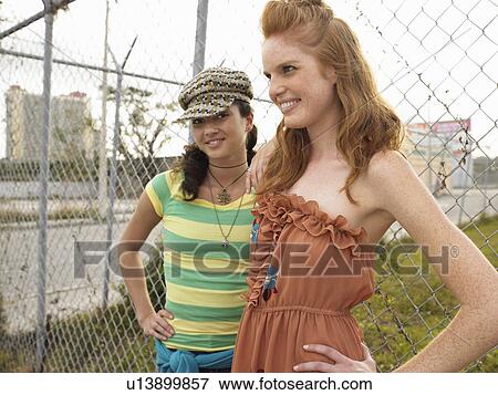 Stock Photo - Two trendy young women, outdoors. Fotosearch
