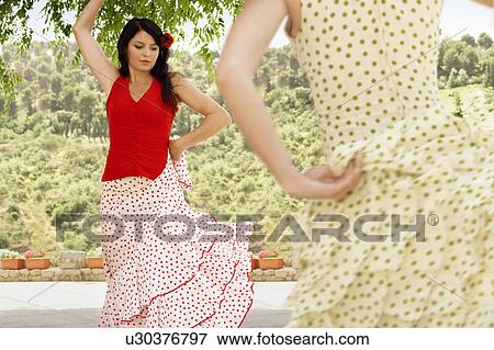 Stock Photo - Two women flamenco dancing outdoors.. Fotosearch