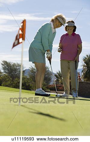 Two women playing golf View Large Photo Image Stock Image - Two women playing golf. Fotosearch