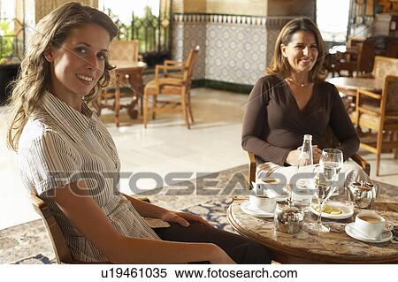 Stock Photography - Two women sitting in restaurant.. Fotosearch