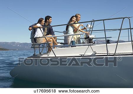 Two young couples sailing on lake View Large Photo Image Stock Photo - Two young couples sailing on lake. Fotosearch